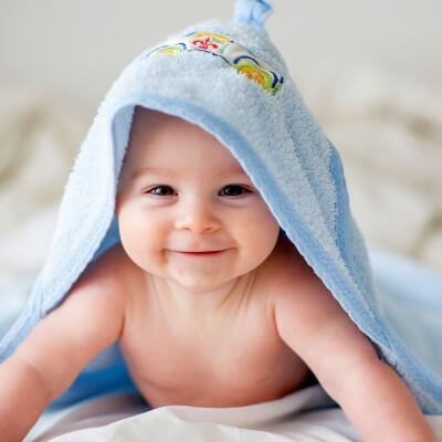 Baby with blue blanket on head