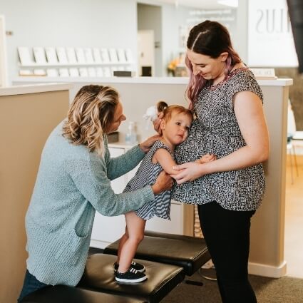 Cedar Park chiropractor Dr Ashley working with mom and child patients