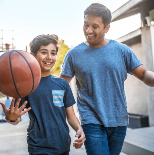 Father and son playing basketball