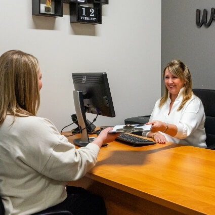 patient being handed paperwork