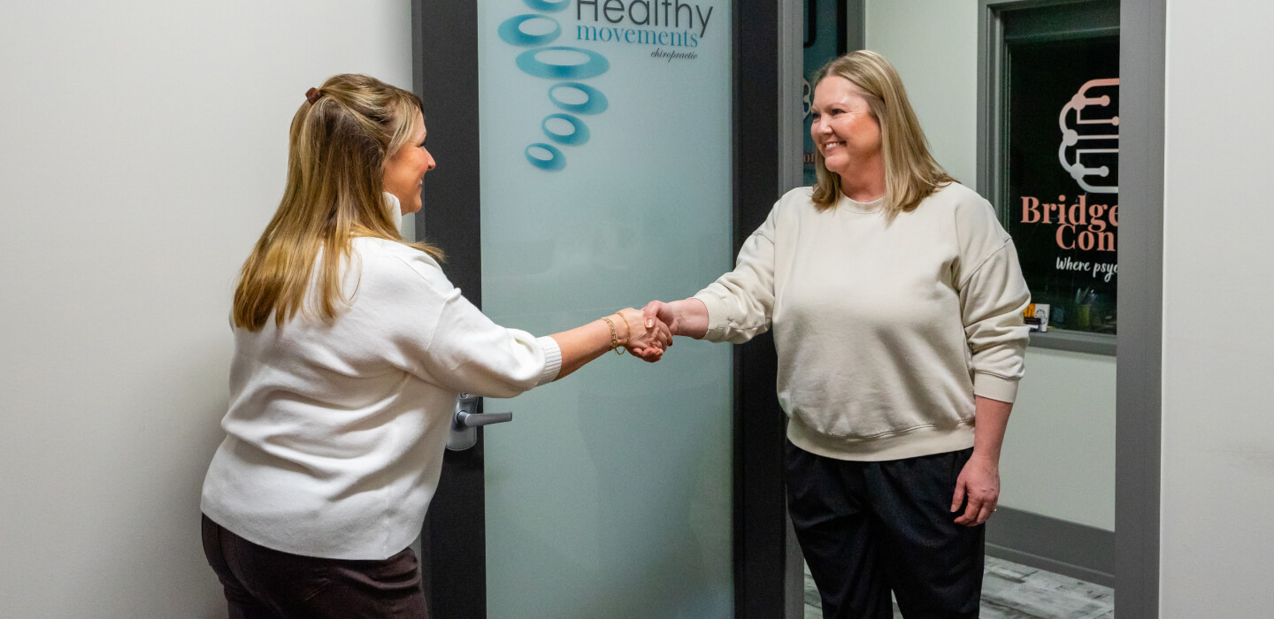 Allen chiropractor Dr. Safina shaking patient hand