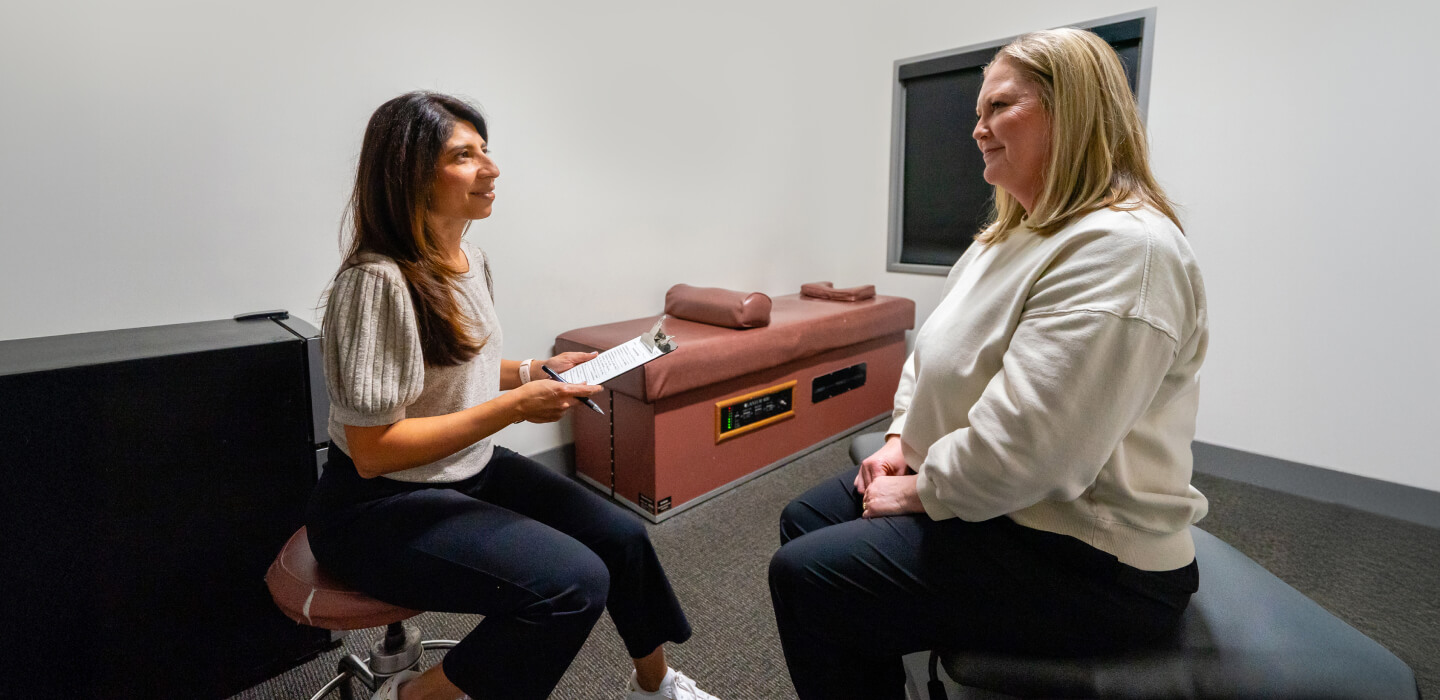 Allen chiropractor Dr. Safina talking to patient