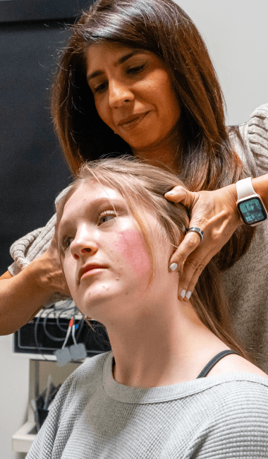 Allen chiropractor Dr. Safina adjusting patient neck