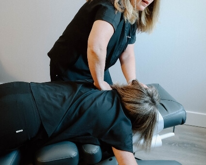 Old Town chiropractor Dr. La Grange adjusting female patient's back