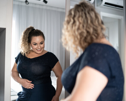 Smiling woman looking at self in mirror