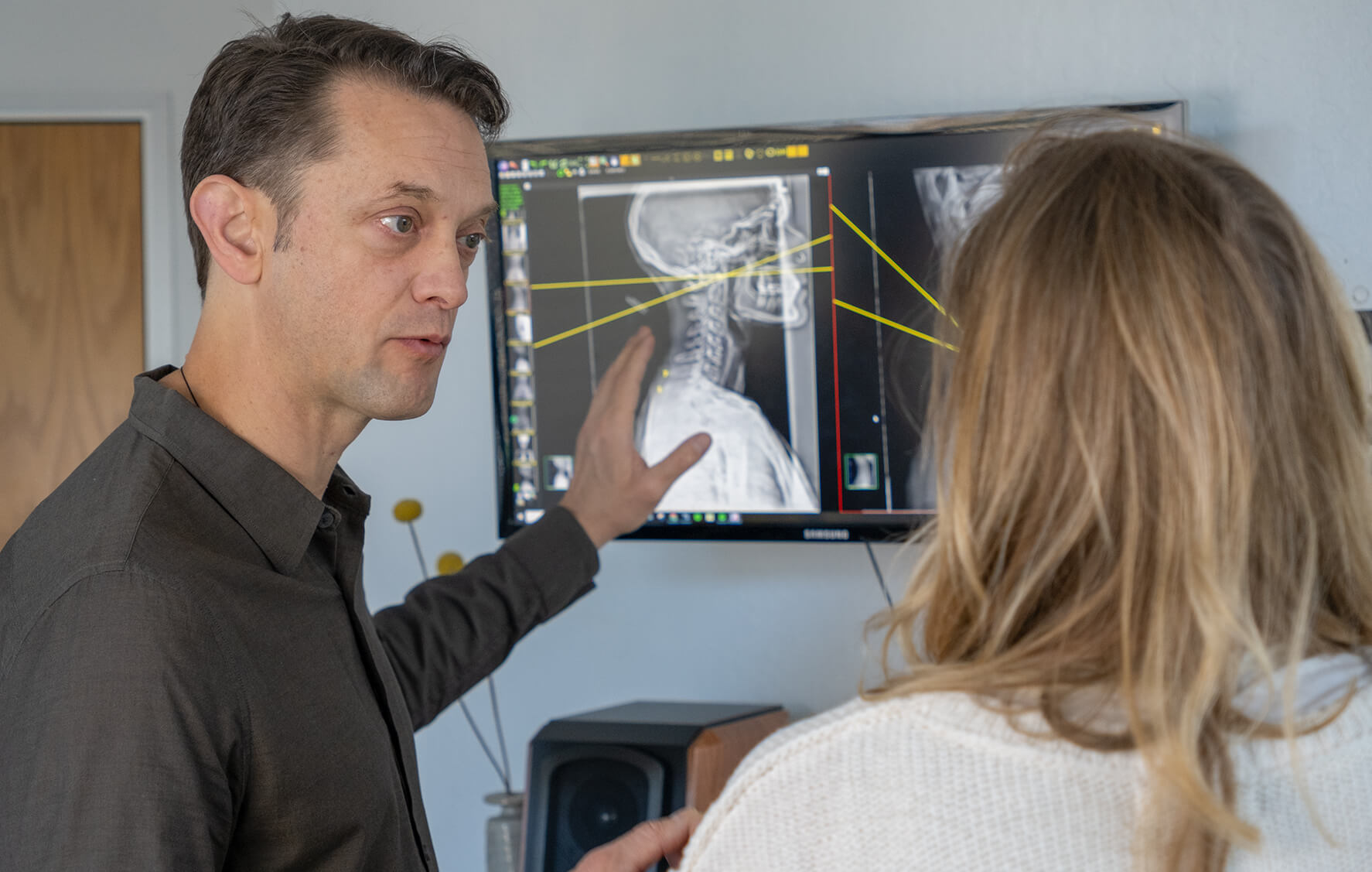 Advanced Spinal Care and Regenerative Medicine Chiropractor Dr. Bennis showing x-ray