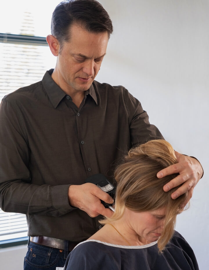 Sebastopol Chiropractor Dr. Bennis using tool on woman's neck