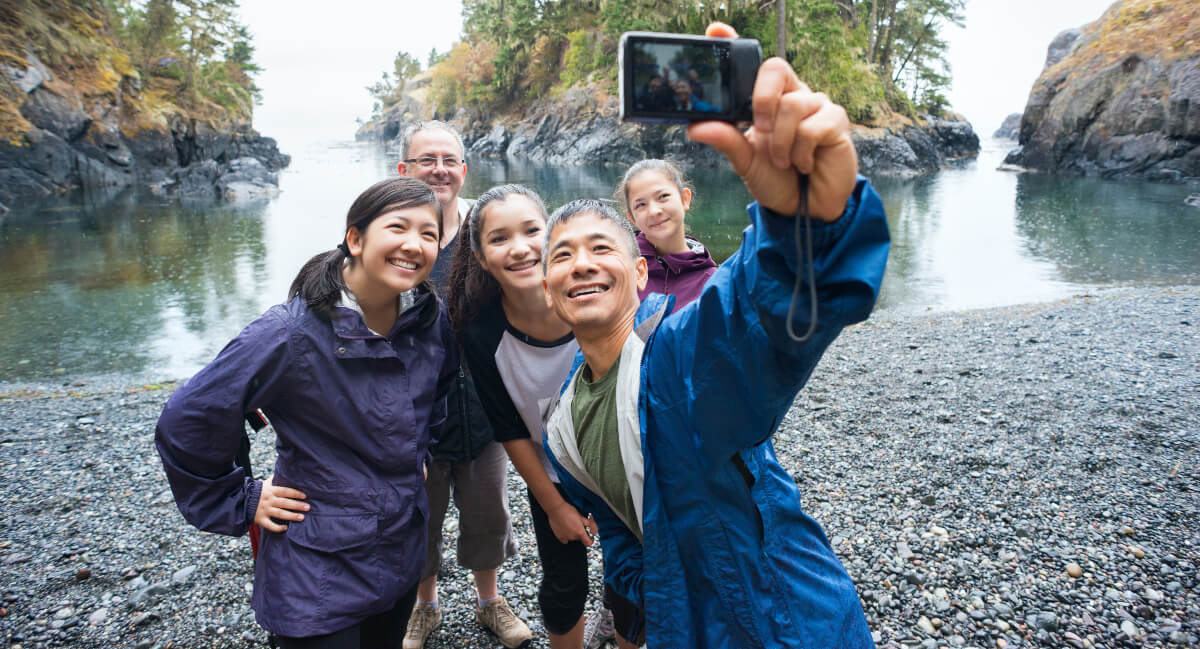 Smiling family taking a selfie outdoors