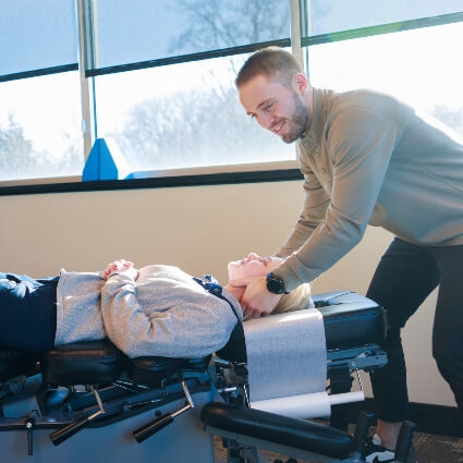 New Hope chiropractor Dr Tanner adjusting patients neck