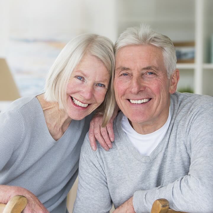 two mature adults smiling