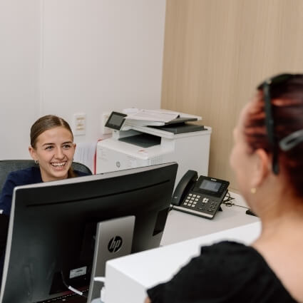 staff with patient at front desk