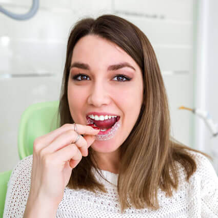 woman fitting clear aligner