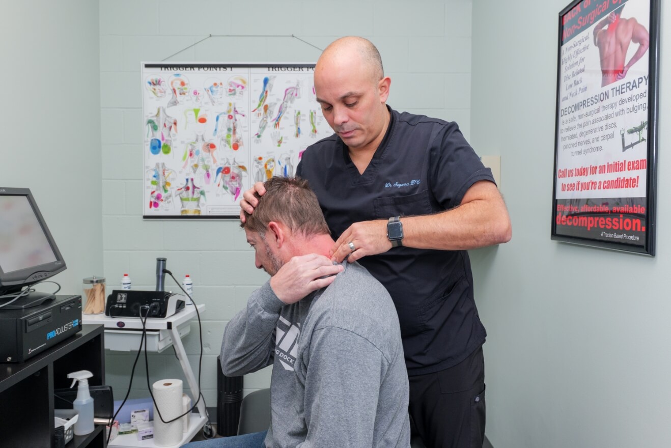 Harrisburg Chiropractor Dr. Andrew Segarra adjusting man's neck