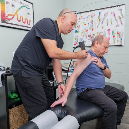 Harrisburg Chiropractor Dr. Andrew using ProAdjuster on patient