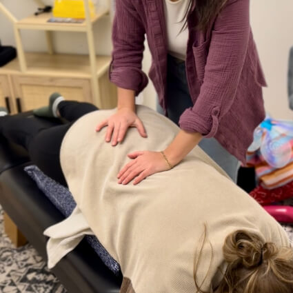 Wilmington chiropractor adjusting patients back