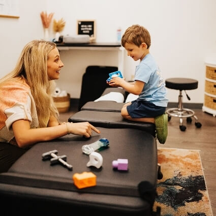 Chiropractor talking to small boy