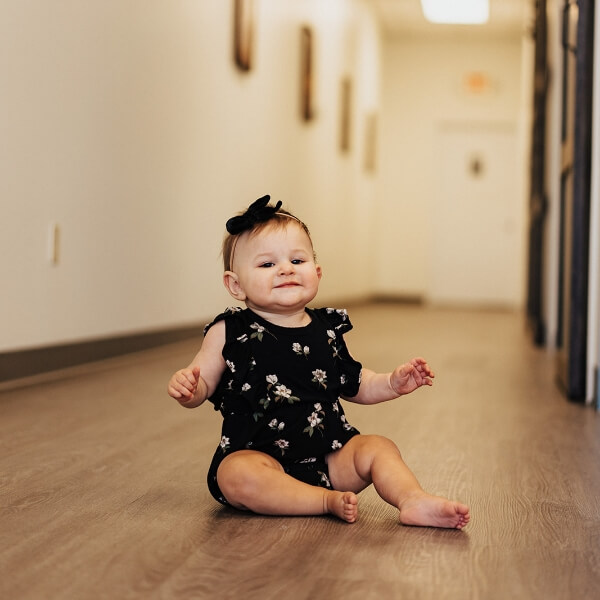 Pediatric patient sitting on floor at Somerset Family Chiropractic