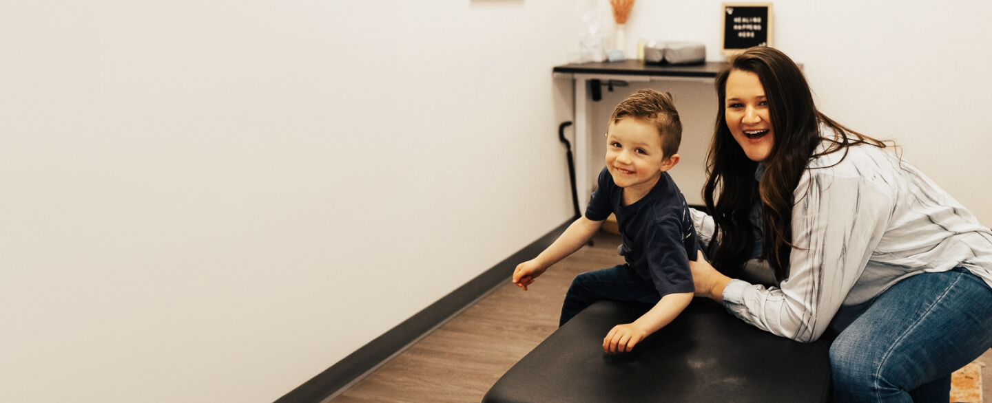 Somerset chiropractor Dr. Andrea Esau adjusting a young boy