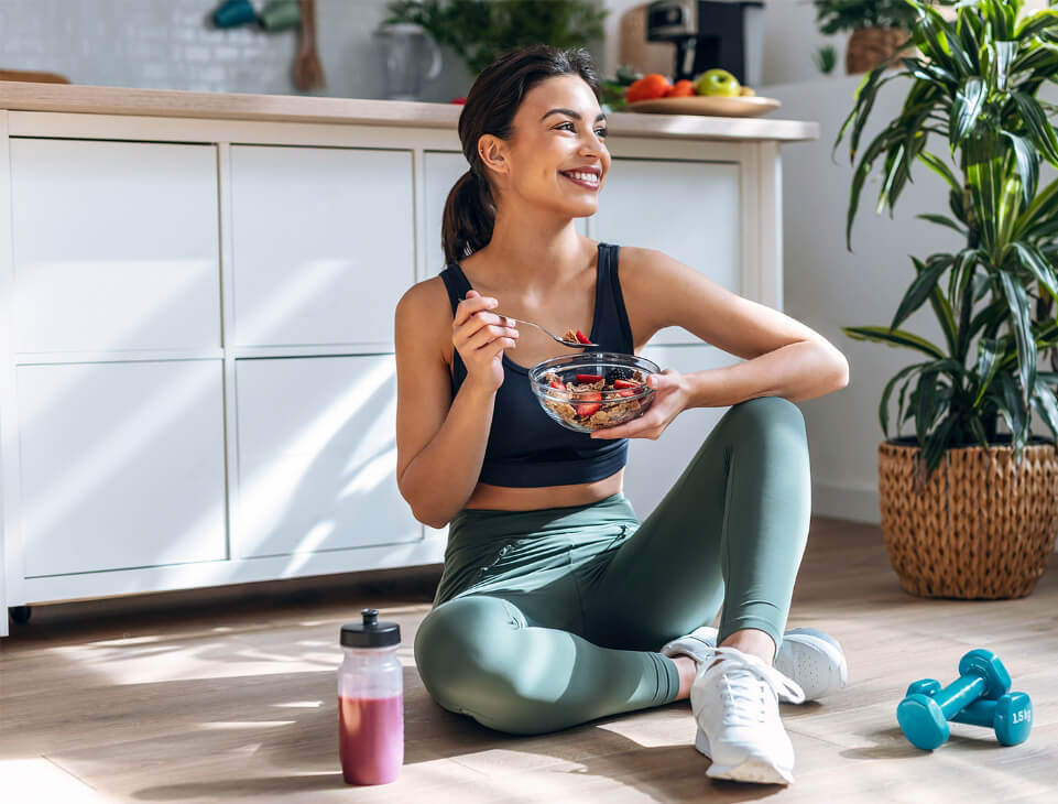 Woman eating bran cereal with strawberries