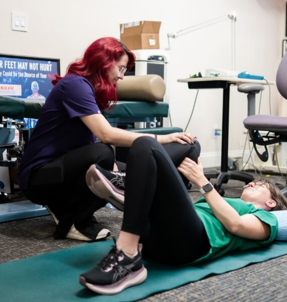 McMurray & Ellahie Chiropractic staff helping patient stretch their legs