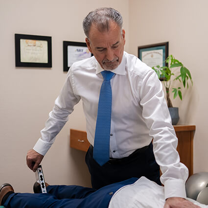 Campbell Chiropractor, Dr. Michael McMurray adjusting lower spine