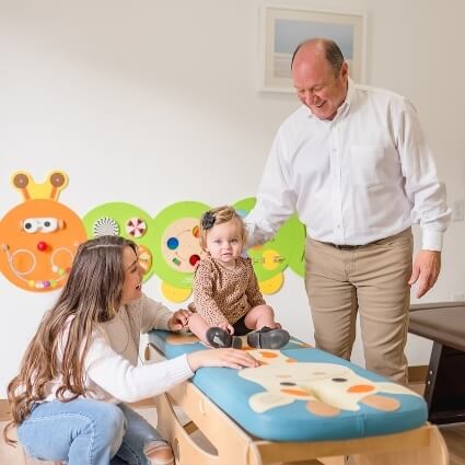 chiropractor talking with patient and family