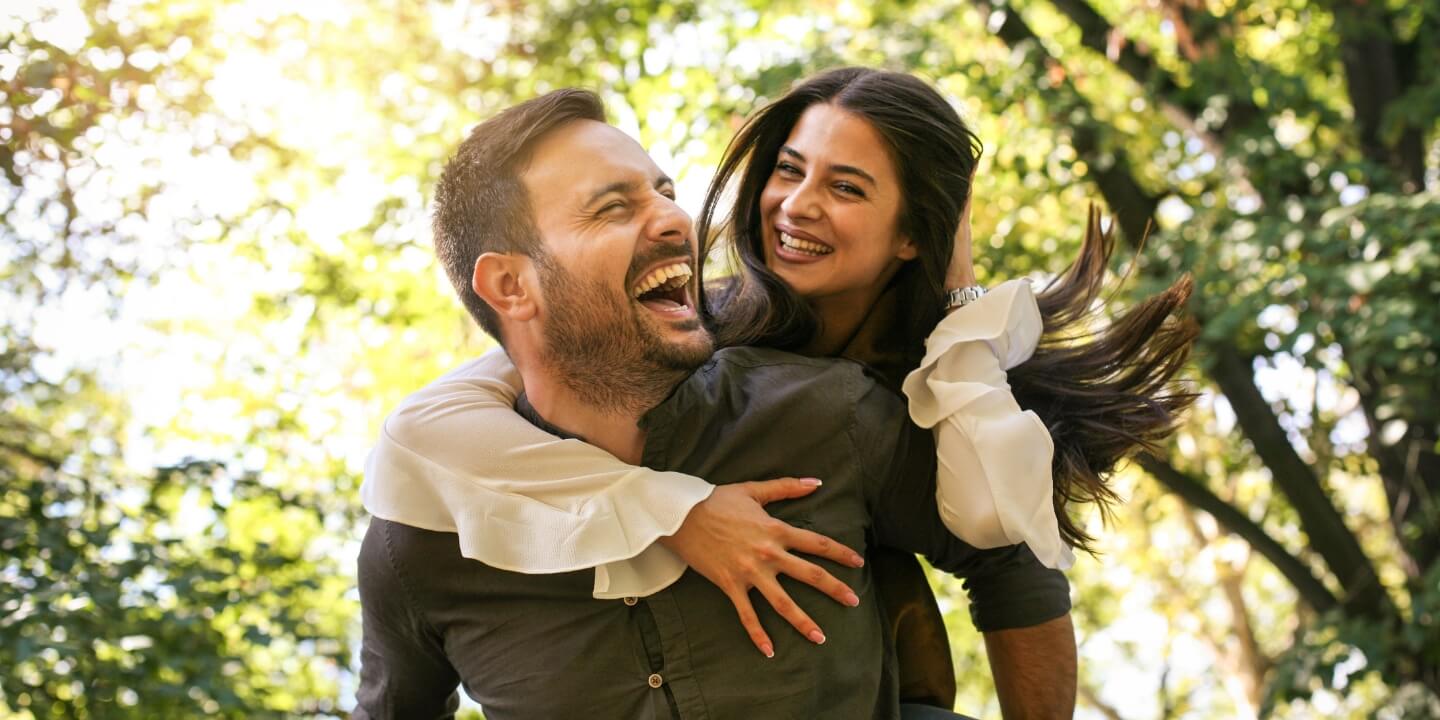 Happy couple hugging outdoors