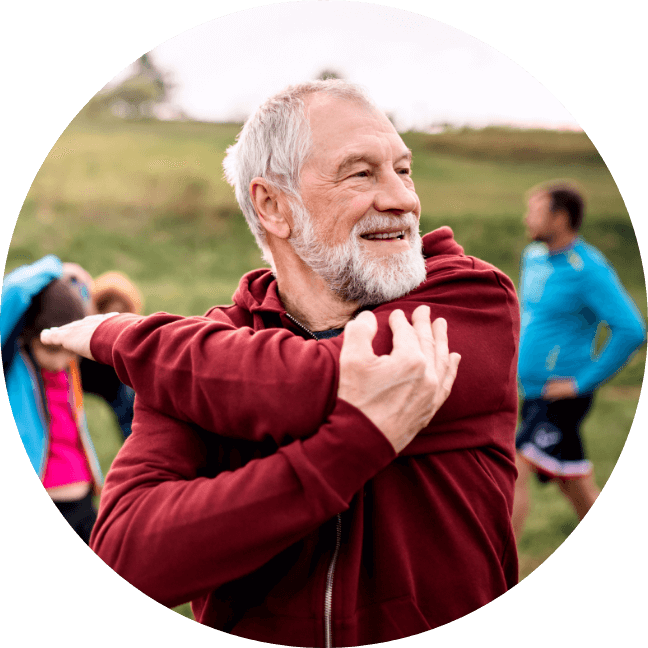 older man stretching outdoors