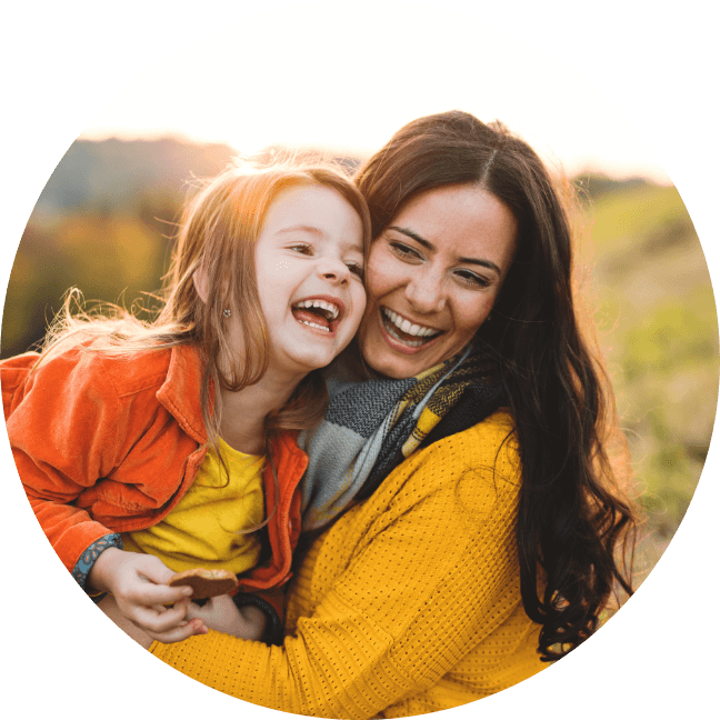 mother and daughter hugging and smiling