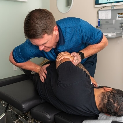 Our chiropractor adjusting patients back