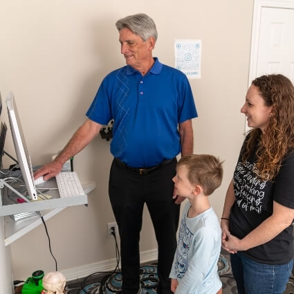 Foley chiropractor showing patients computer