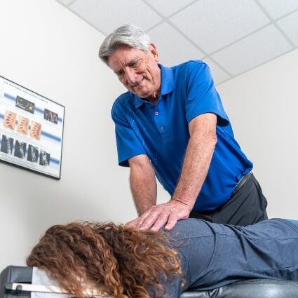 Our chiropractor adjusting patients back