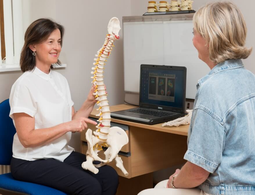 Chiropractor talking to patient