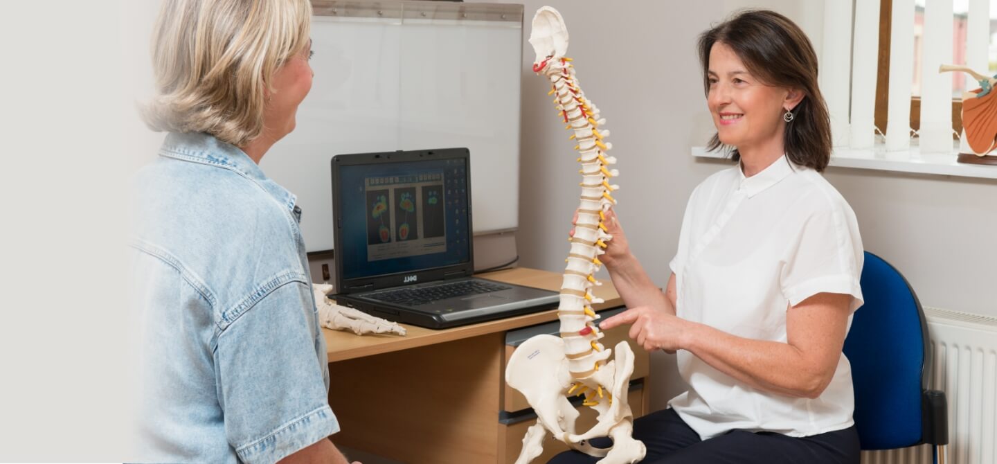 Chiropractor talking to patient