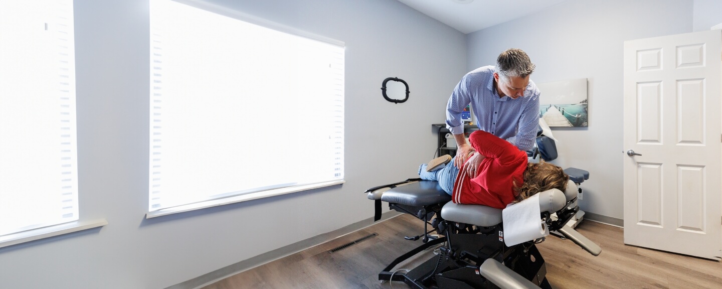 Female patient getting her lower-back adjusted at Back Pain Clinic