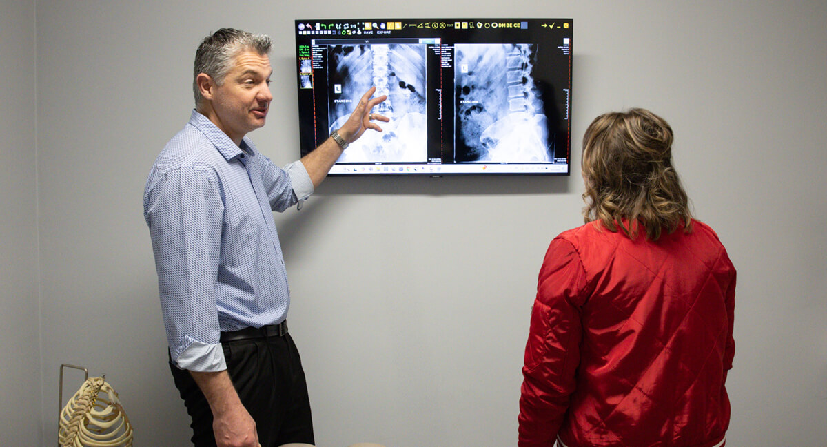 Belleville chiropractor Dr. Rob Fast discussing x-rays with patient