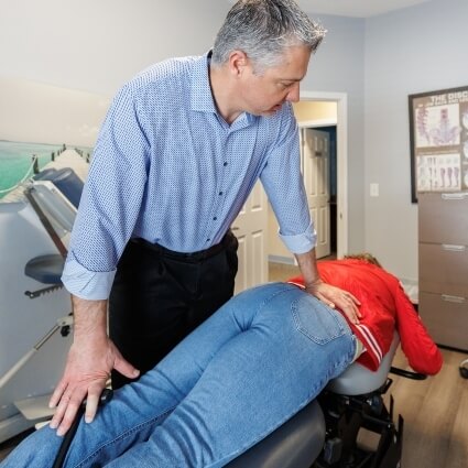 Dr. Fast applying mid-back pressure to patient