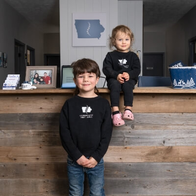 Two kids at Chiropractic First of Iowa office