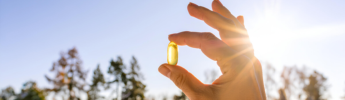 hand holding capsule in sunrise