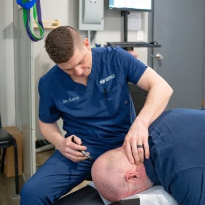 Sioux City Chiropractor Dr. Cody adjusting patient