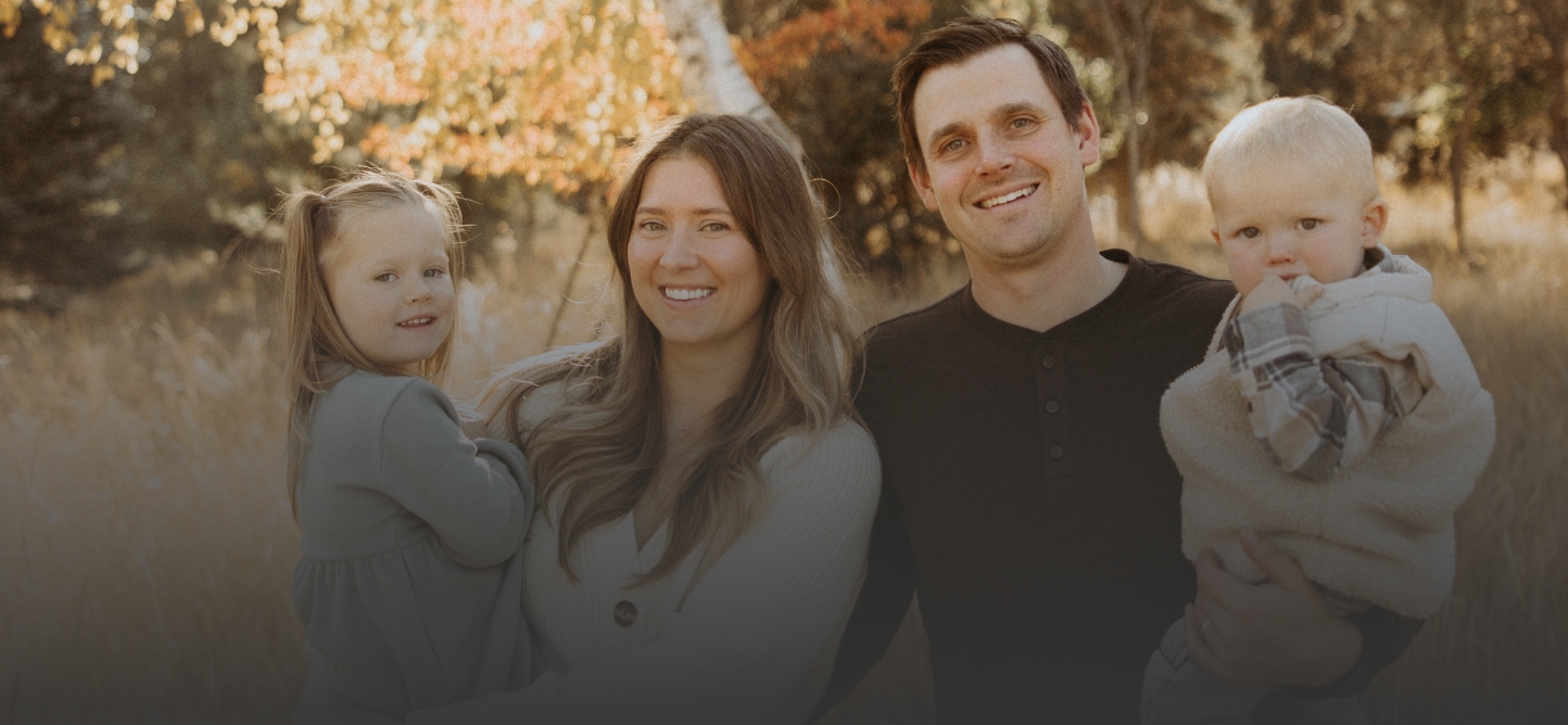 family of four smiling
