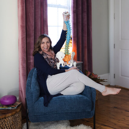 Dr. Vanessa holding spine model