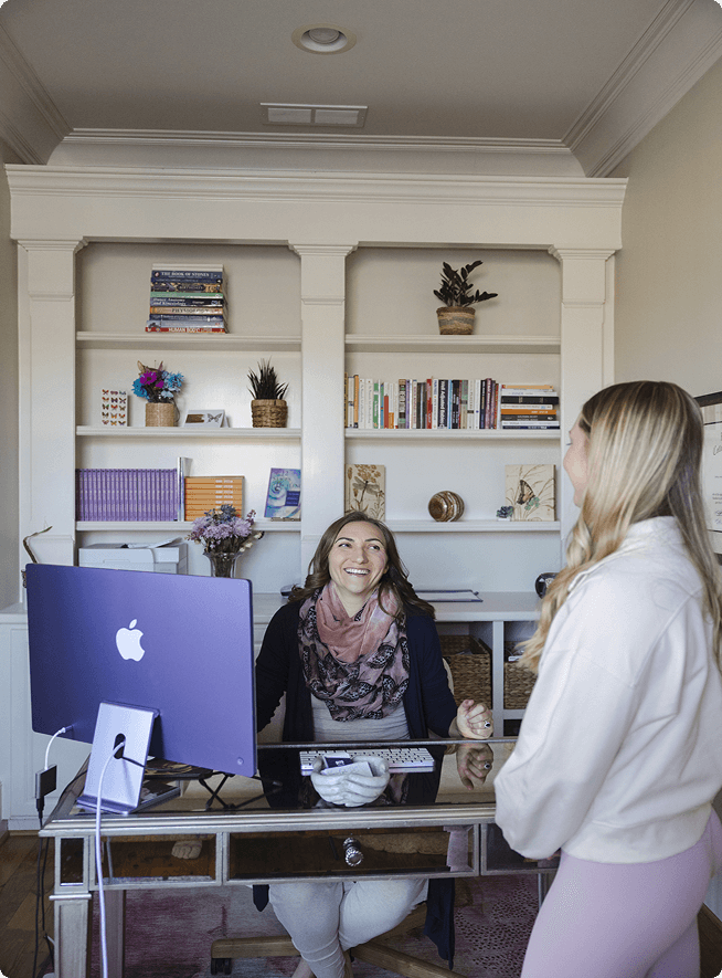 Dr. Vanessa Gale talking with yoga student