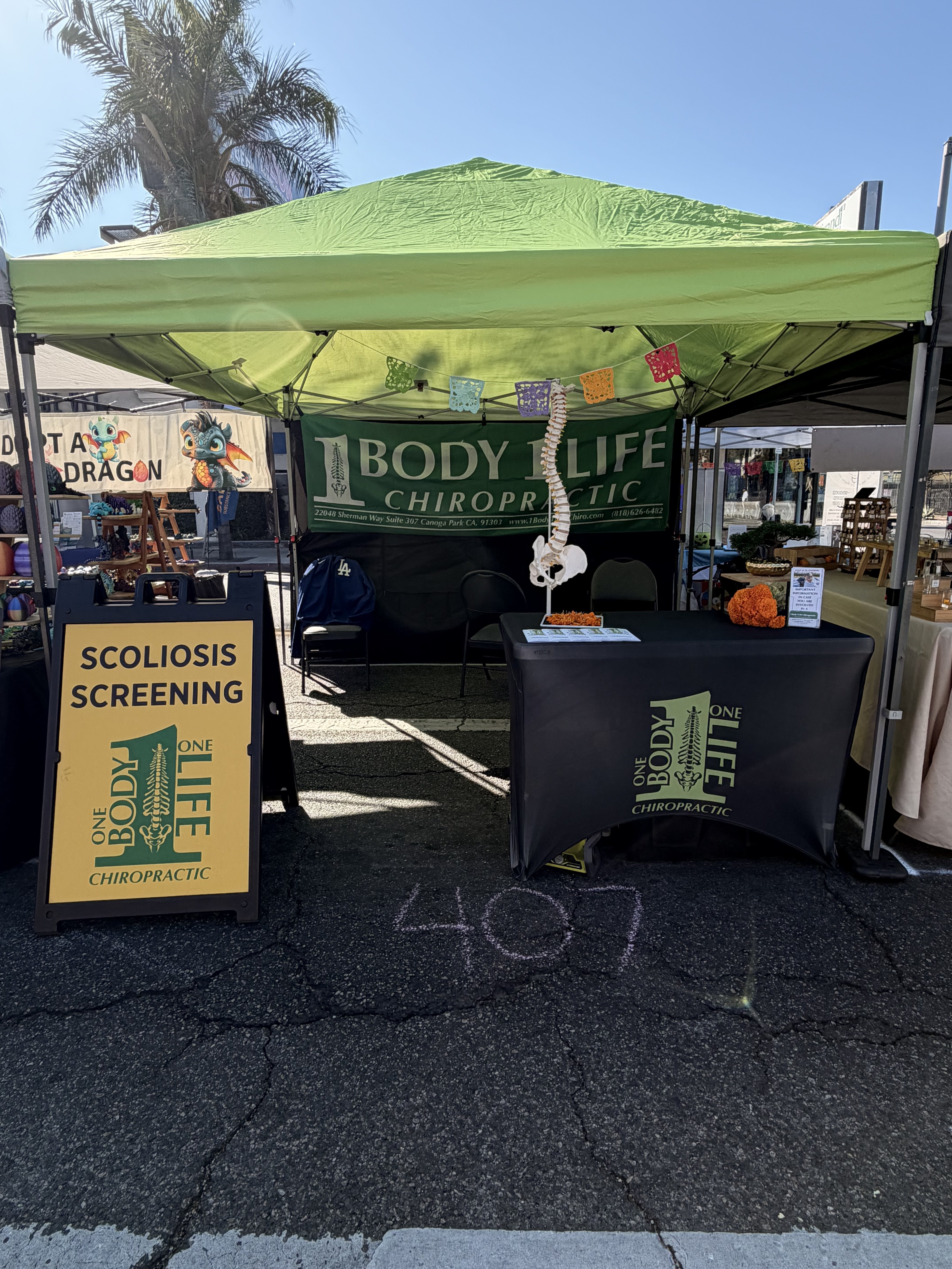 1 Body 1 Life Chiropractic scoliosis screening booth at Canoga Park Día de los Muertos Family Festival
