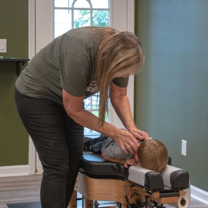 chiropractor adjusting childs neck