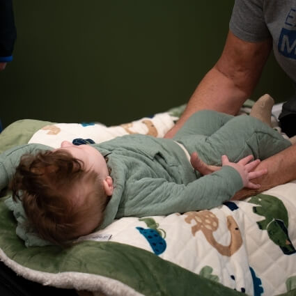 chiropractor adjusting babys hips