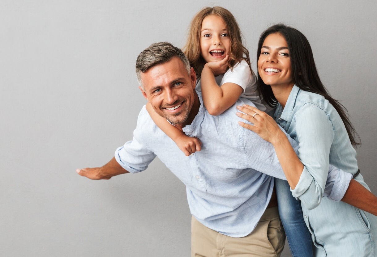 family of 3 smiling together