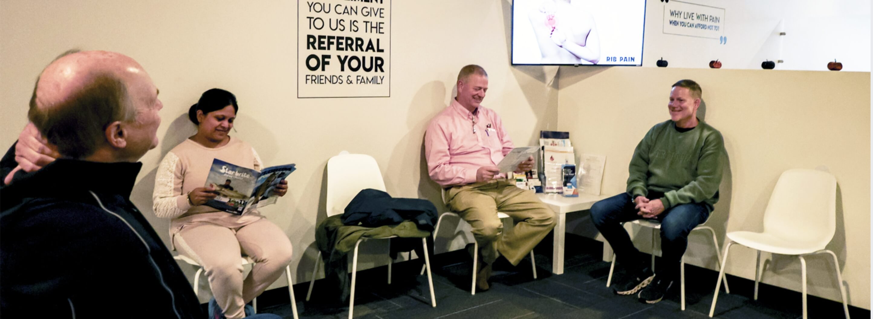 Dr. Pranav using a chiropractic tool to adjust a Flowery Branch patient