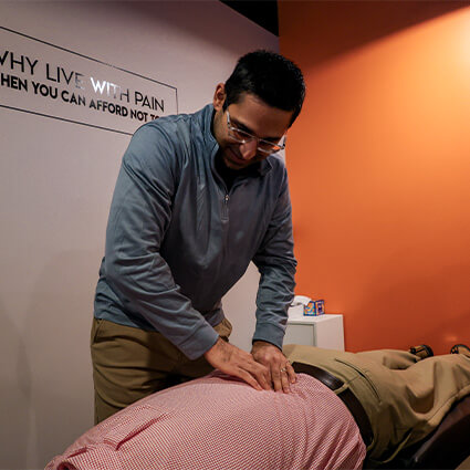 Dr Halvawala adjusting man's back