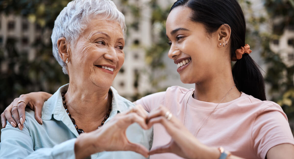 Two women making heart shape with hands